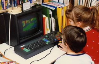 Children playing on a Amstrad CPC 464 in the 1980s.